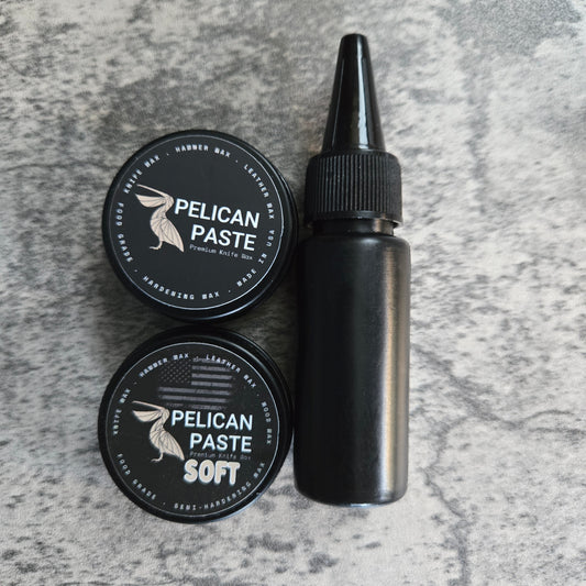 Two small black tins of Pelican Paste and a small black bottle of Pelican Oil